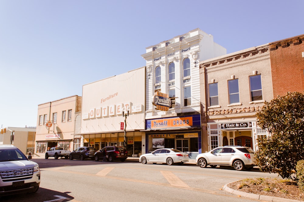 cars parked in front of beige concrete building during daytime