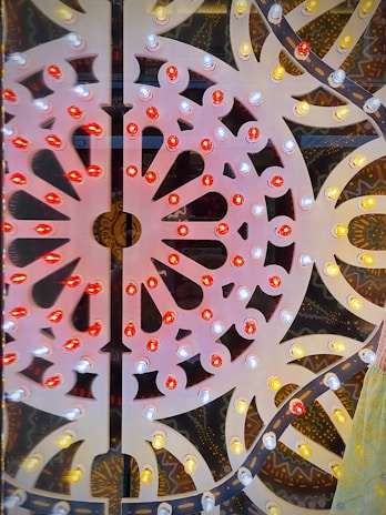 Artistic photo of a fileteado panel with vibrant reds, blues, and gold accents.