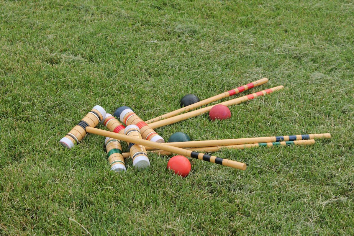 croquet set on a manicured green lawn