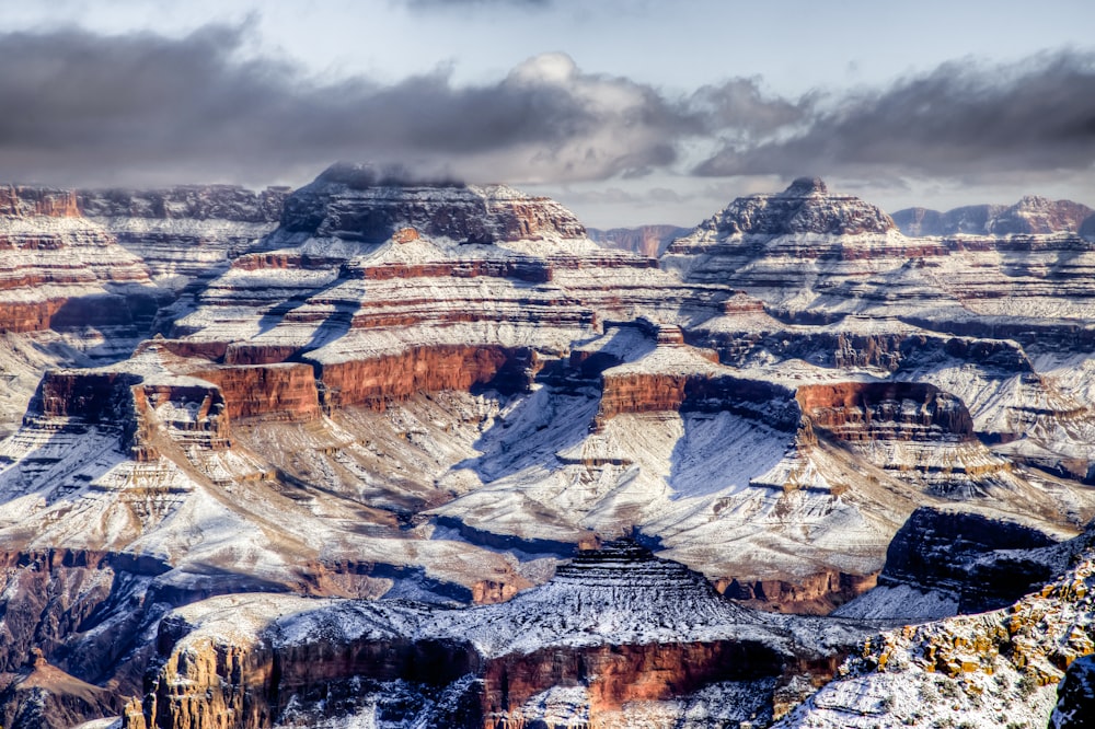 brown and gray rock formation under gray clouds