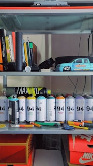orange and gray toy car on white wooden shelf
