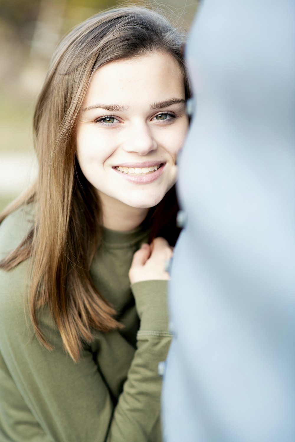 smiling woman in green long sleeve shirt