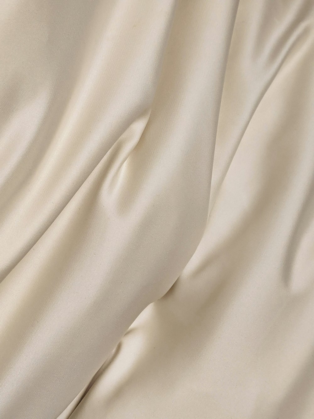 white textile on brown wooden table