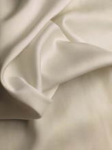 white textile on brown wooden table