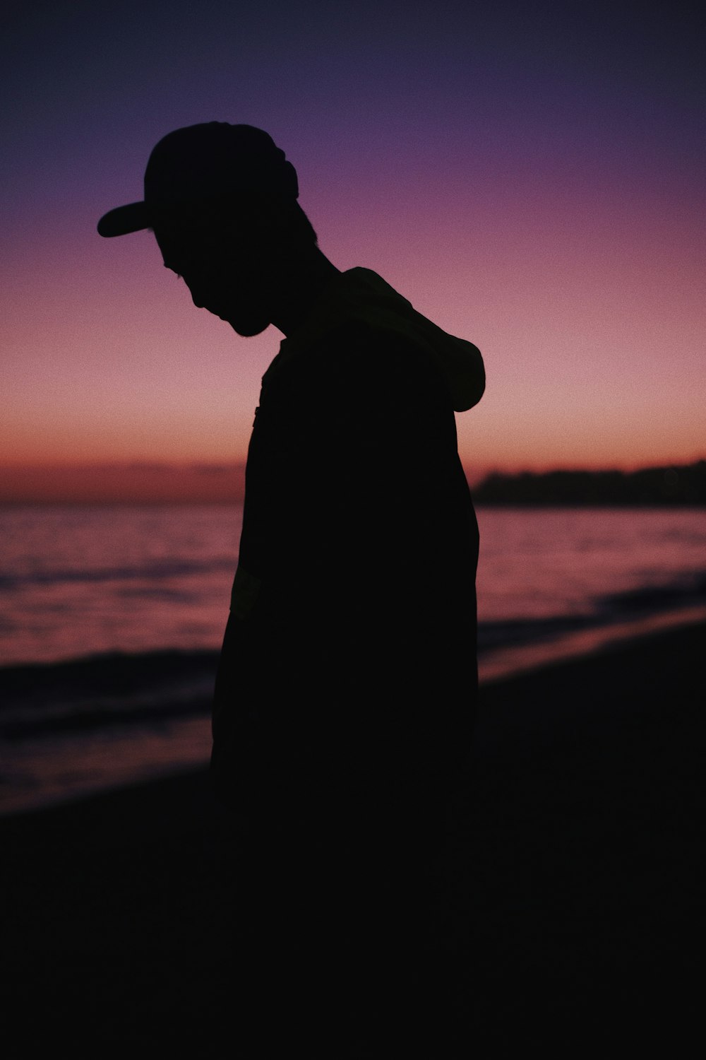 silhouette of man wearing hat during sunset