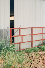 Finished metal gates installed at an agricultural facility entrance.