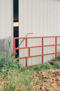 Finished metal gates installed at an agricultural facility entrance.