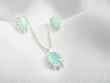 Bridal set featuring a shimmering necklace and matching earrings against a soft white background