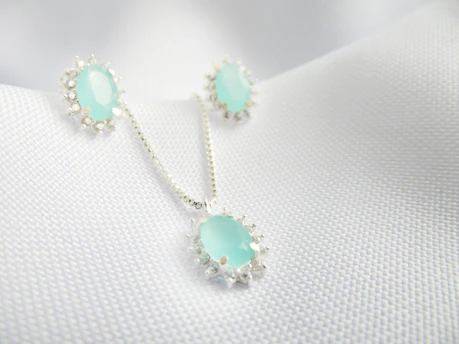 A charming kids' jewellery set featuring a ring and necklace with playful designs displayed on a white surface