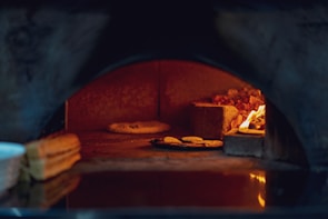 Inside view of Rize Pidesi restaurant showing the traditional pide oven with glowing embers.