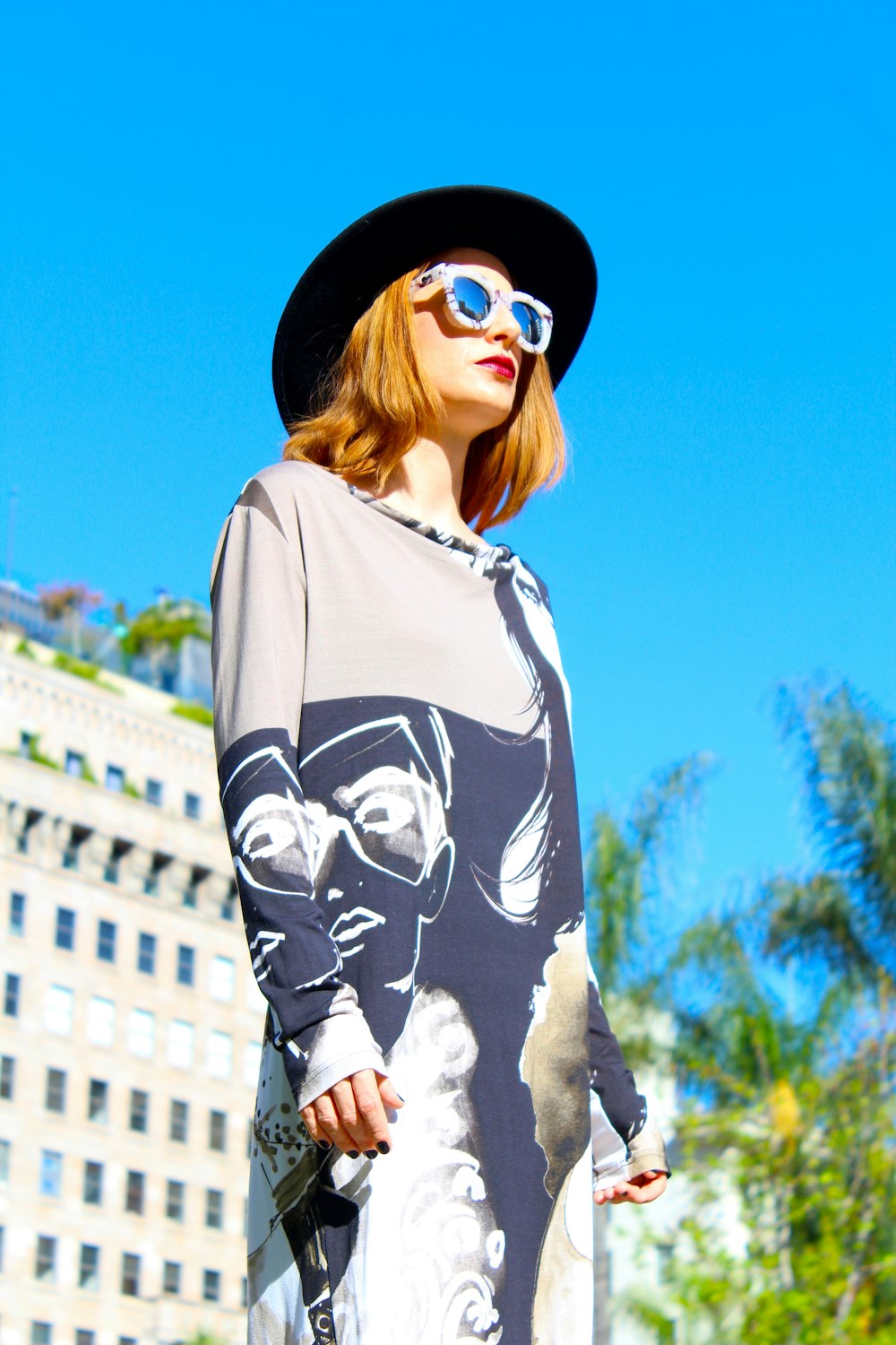 woman in white and black mickey mouse long sleeve shirt wearing black sunglasses