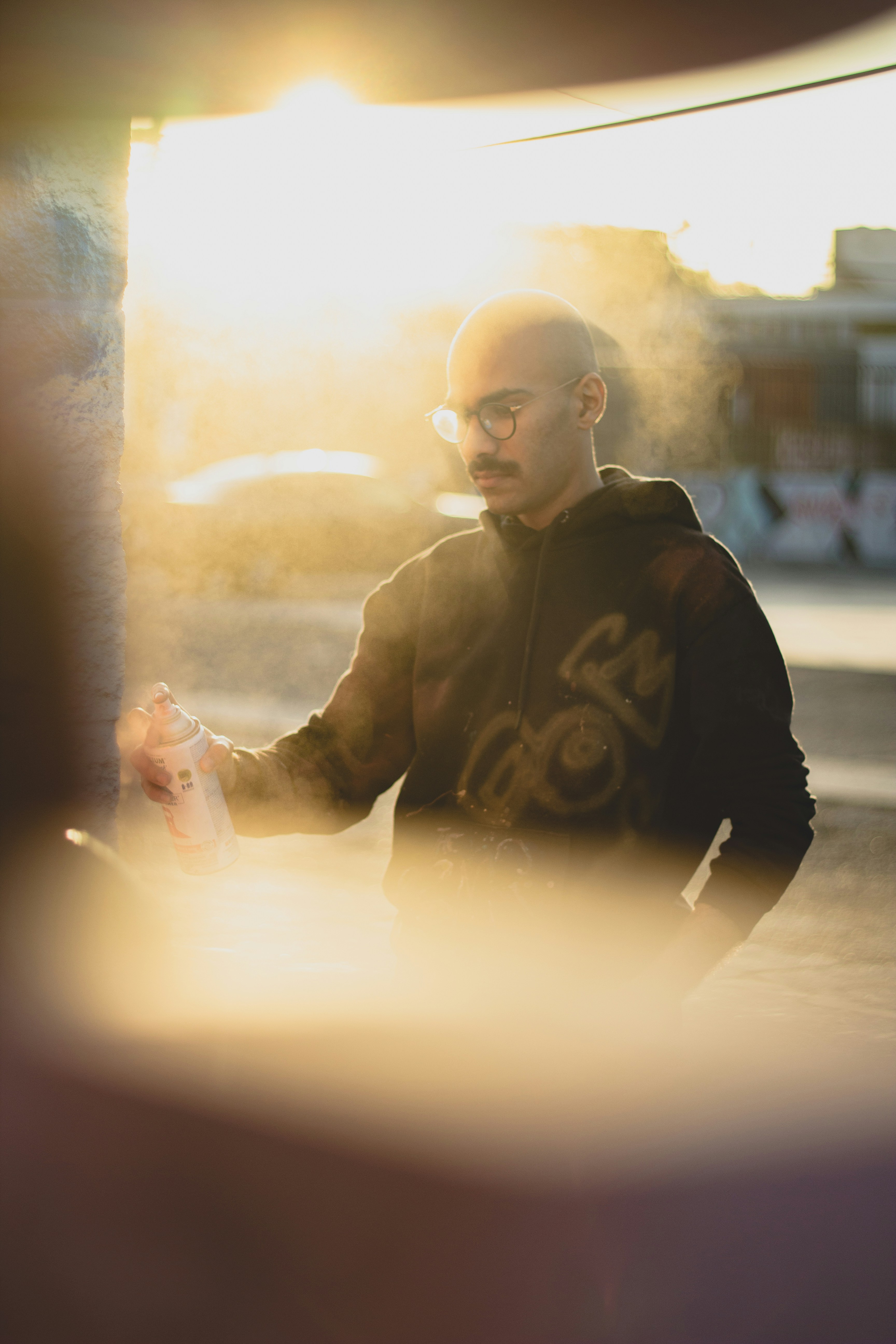 man in black hoodie holding smartphone