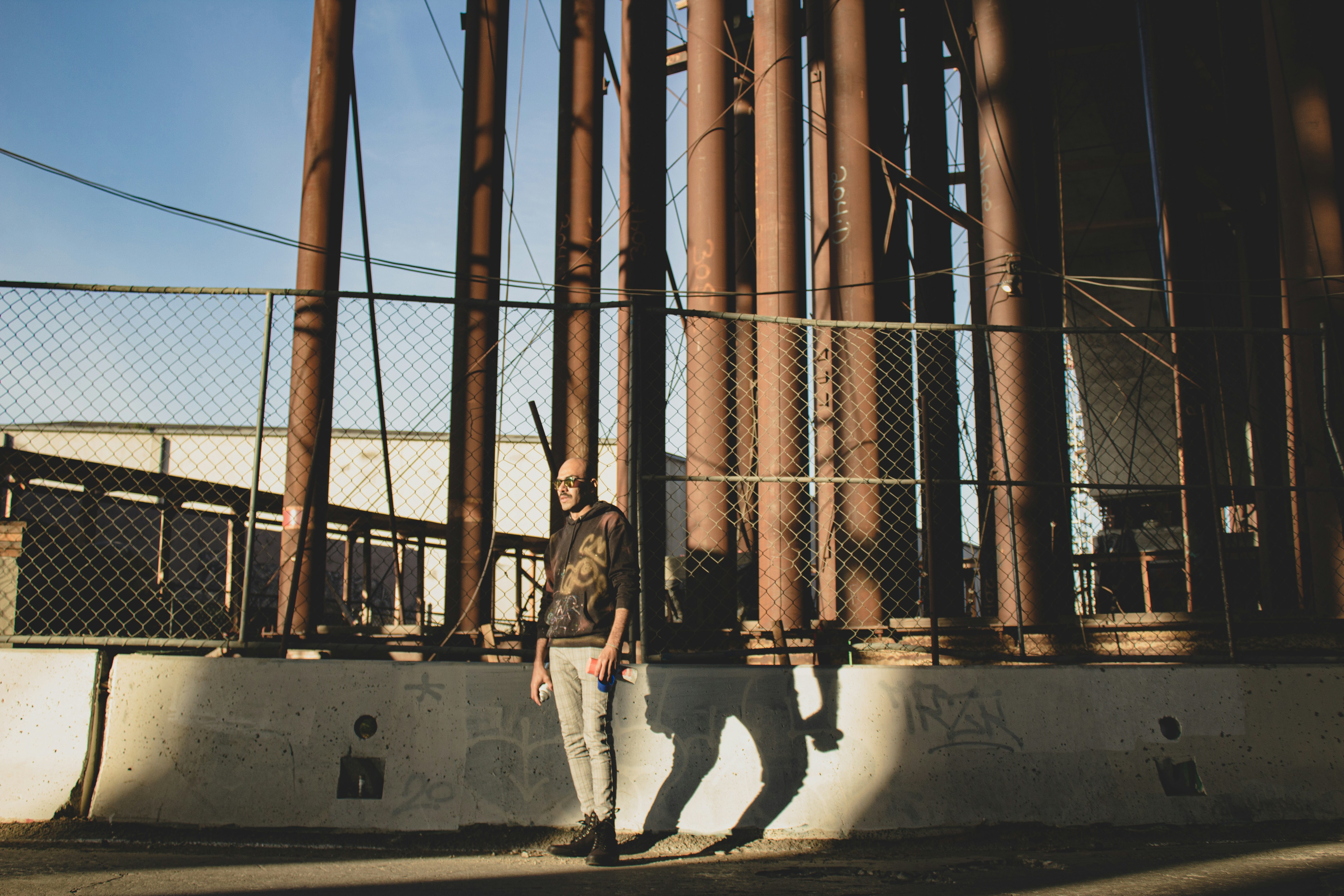 2 men standing on concrete wall during daytime
