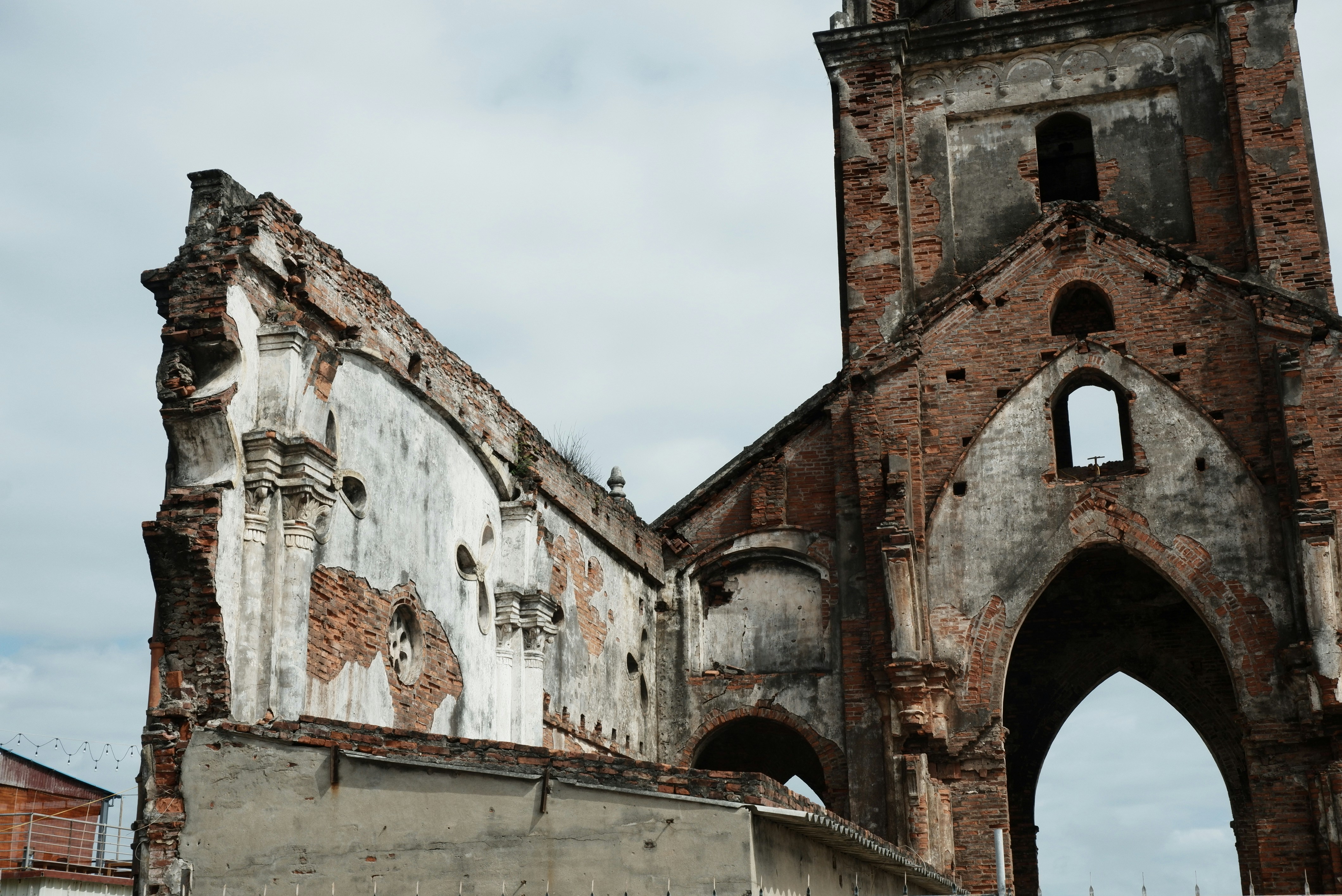 white and brown concrete building under white clouds during daytime (Photo by Do Hoang Anh on Unsplash)