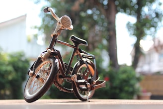 A finished bicycle model standing proudly by the studio window with Guangzhou cityscape behind.