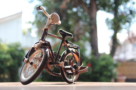 A finished bicycle model standing proudly by the studio window with Guangzhou cityscape behind.