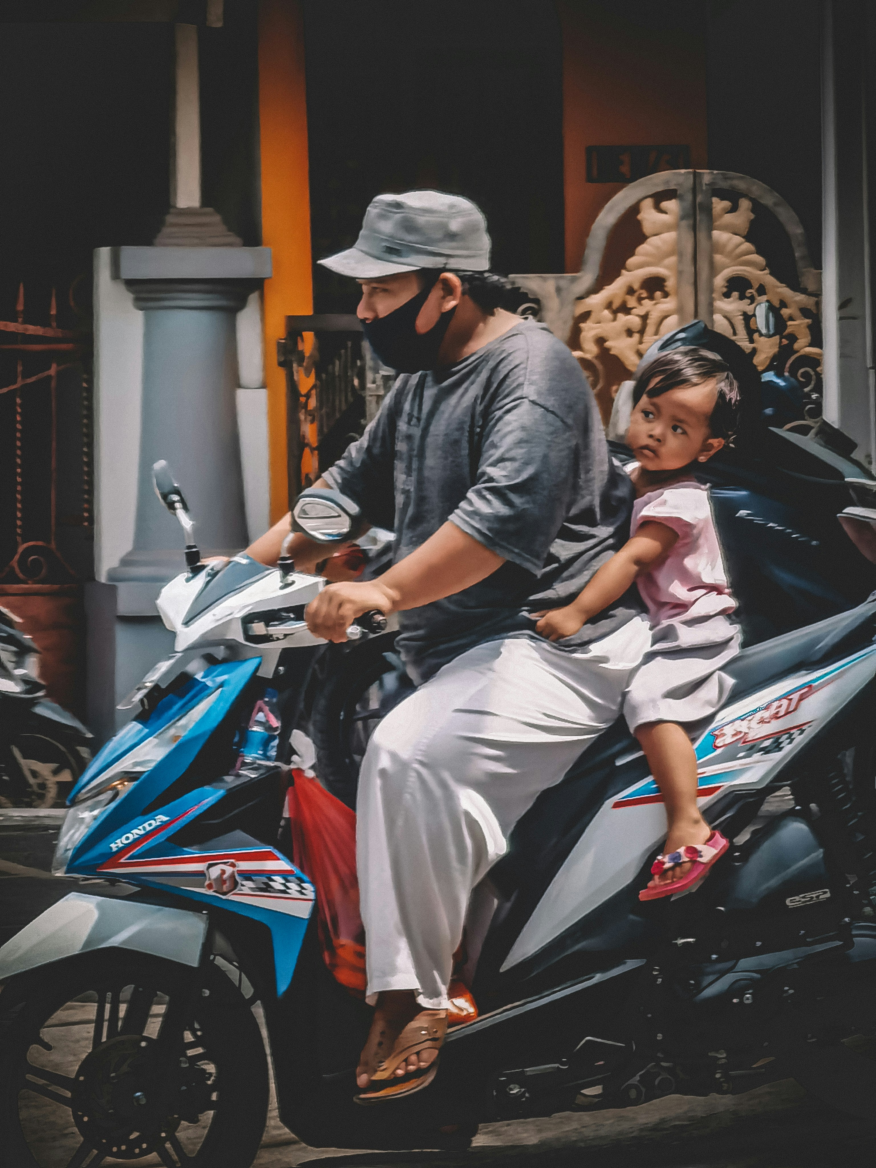 Pria dan wanita mengendarai sepeda motor merah dan hitam
