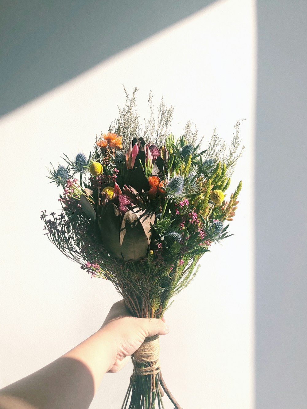 personne tenant un bouquet de fleurs