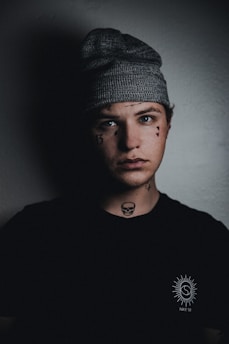 man in black crew neck shirt wearing black knit cap