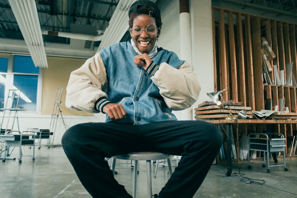 man in gray dress shirt and black pants sitting on chair