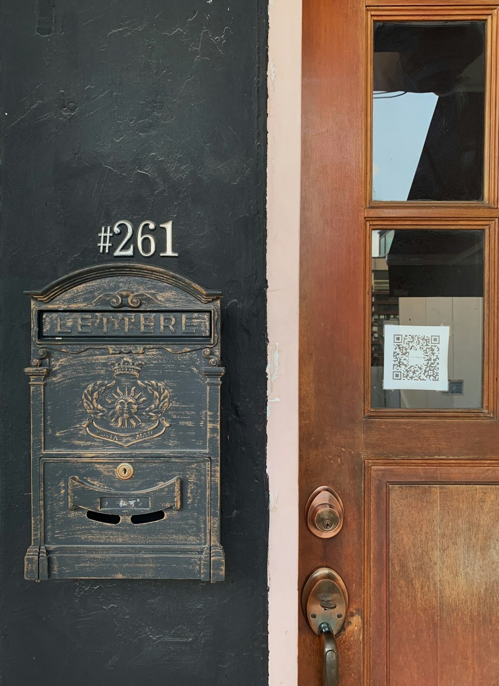 brown wooden door with black steel door lever