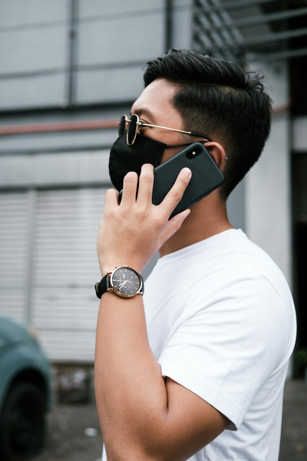 a man wearing a face mask while talking on a cell phone