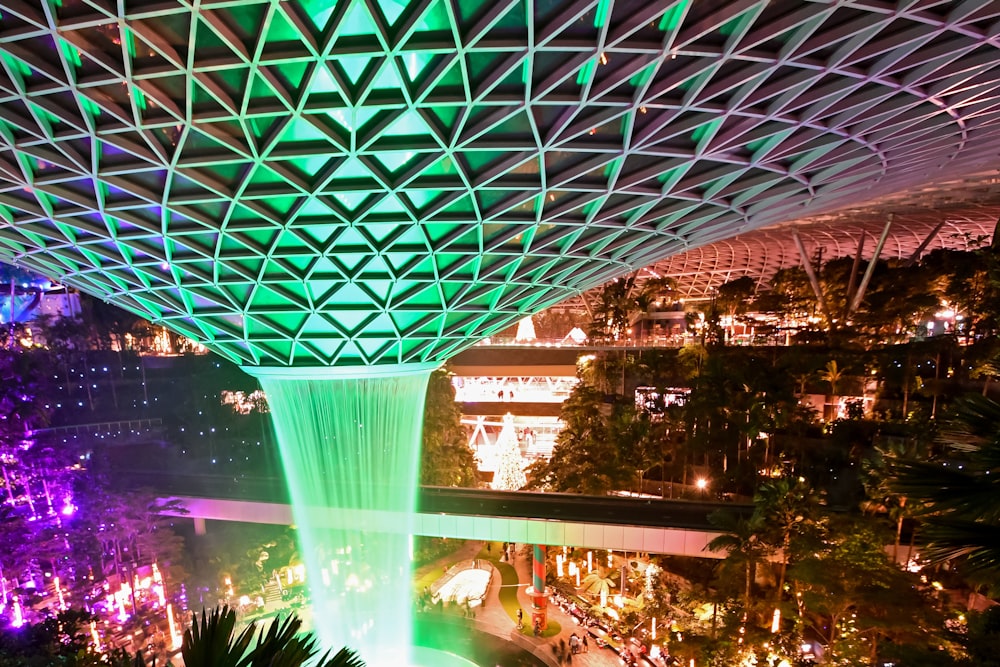 people in a building with green glass roof