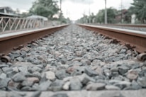 A close-up of railway tracks blending into the horizon, emphasizing the connection between innovation and the railway industry.
