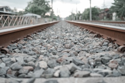A close-up of railway tracks blending into the horizon, emphasizing the connection between innovation and the railway industry.