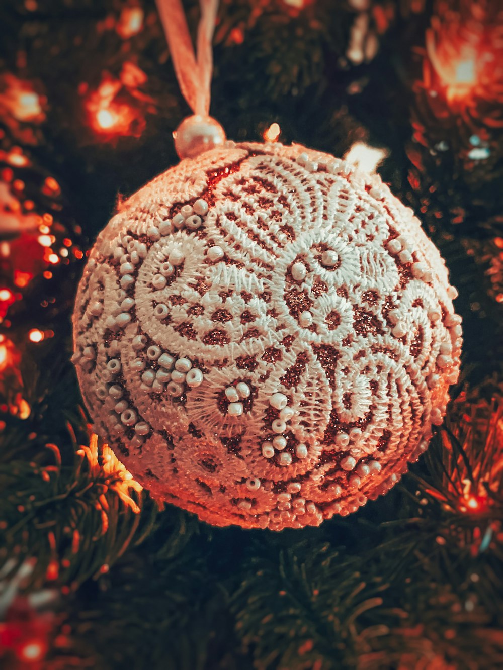 white round ball ornament on red string lights