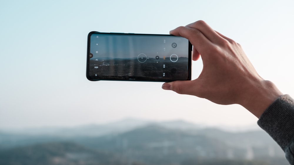 person holding black android smartphone