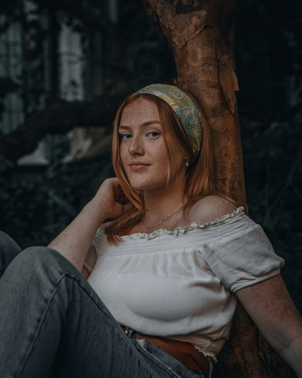 woman in white dress sitting on brown wooden chair