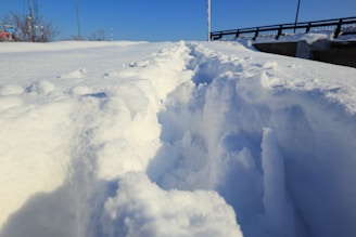 A freshly shoveled walkway lined with snowbanks, showing the clear path after a morning job.