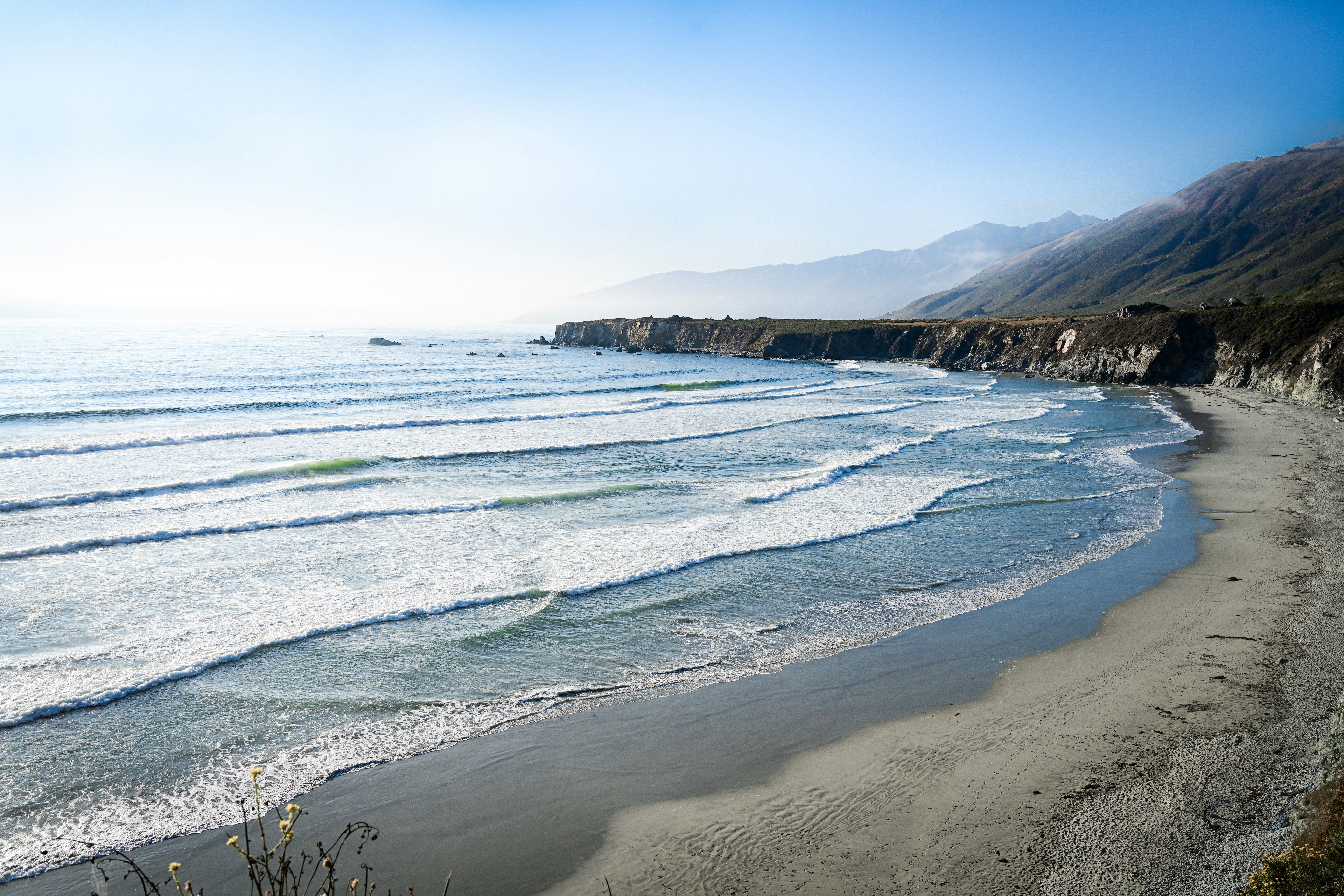 ocean waves crashing on shore during daytime