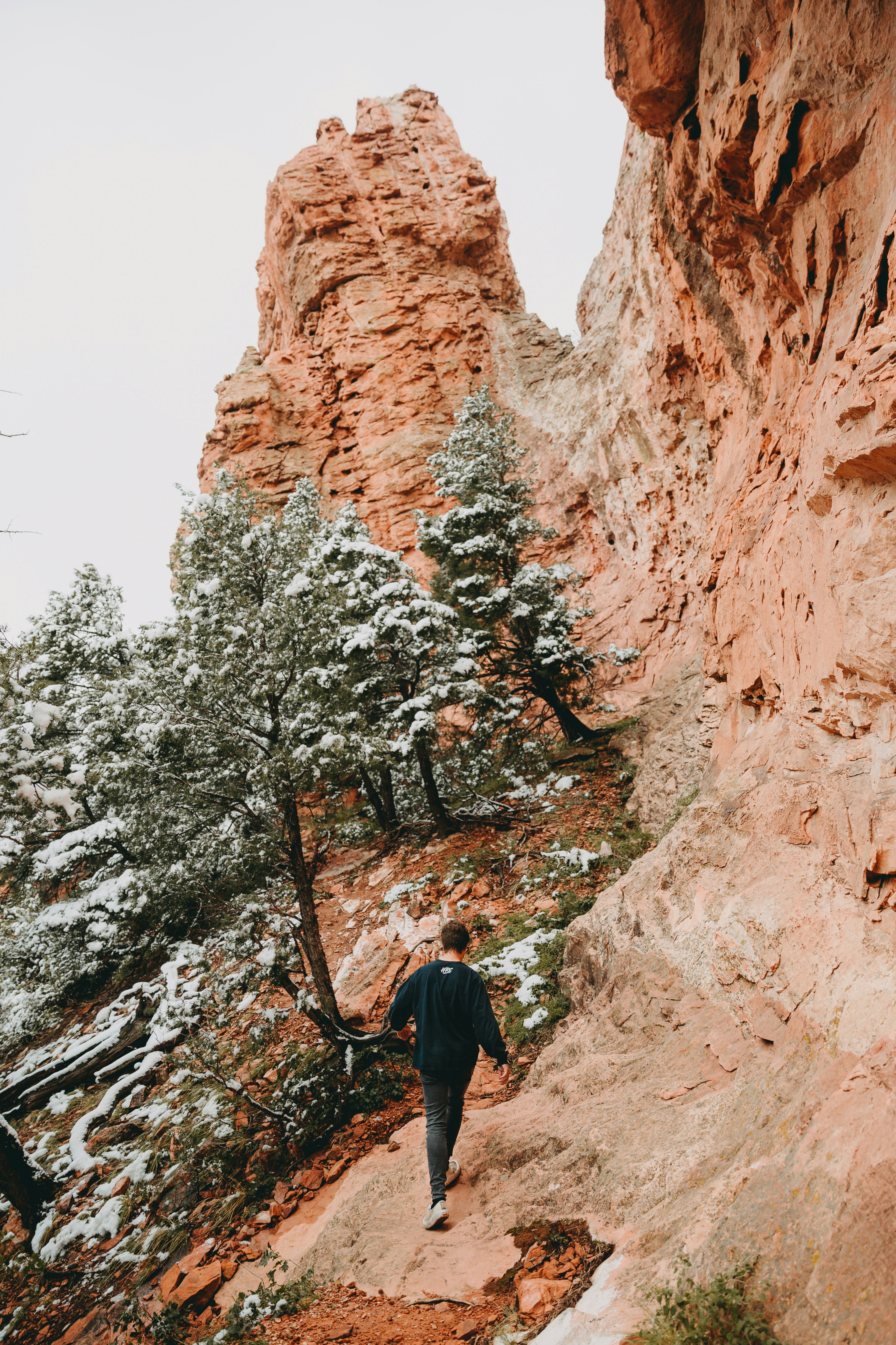 woman in black jacket standing on rocky hill during daytime