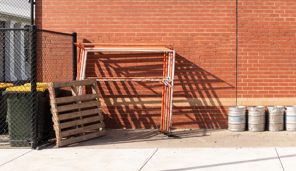 brown wooden chair beside brown brick wall