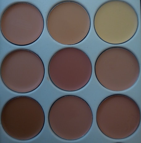 An array of pigments and tools used in permanent makeup artistry.