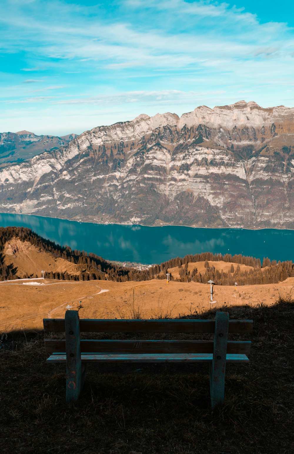 brown wooden fence near snow covered mountain during daytime