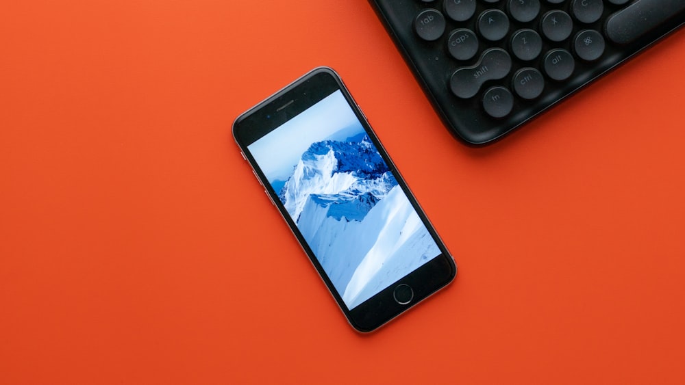 black iphone 5 on red table