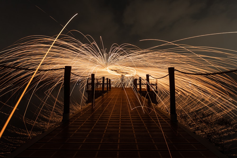 brown wooden dock on sea during night time