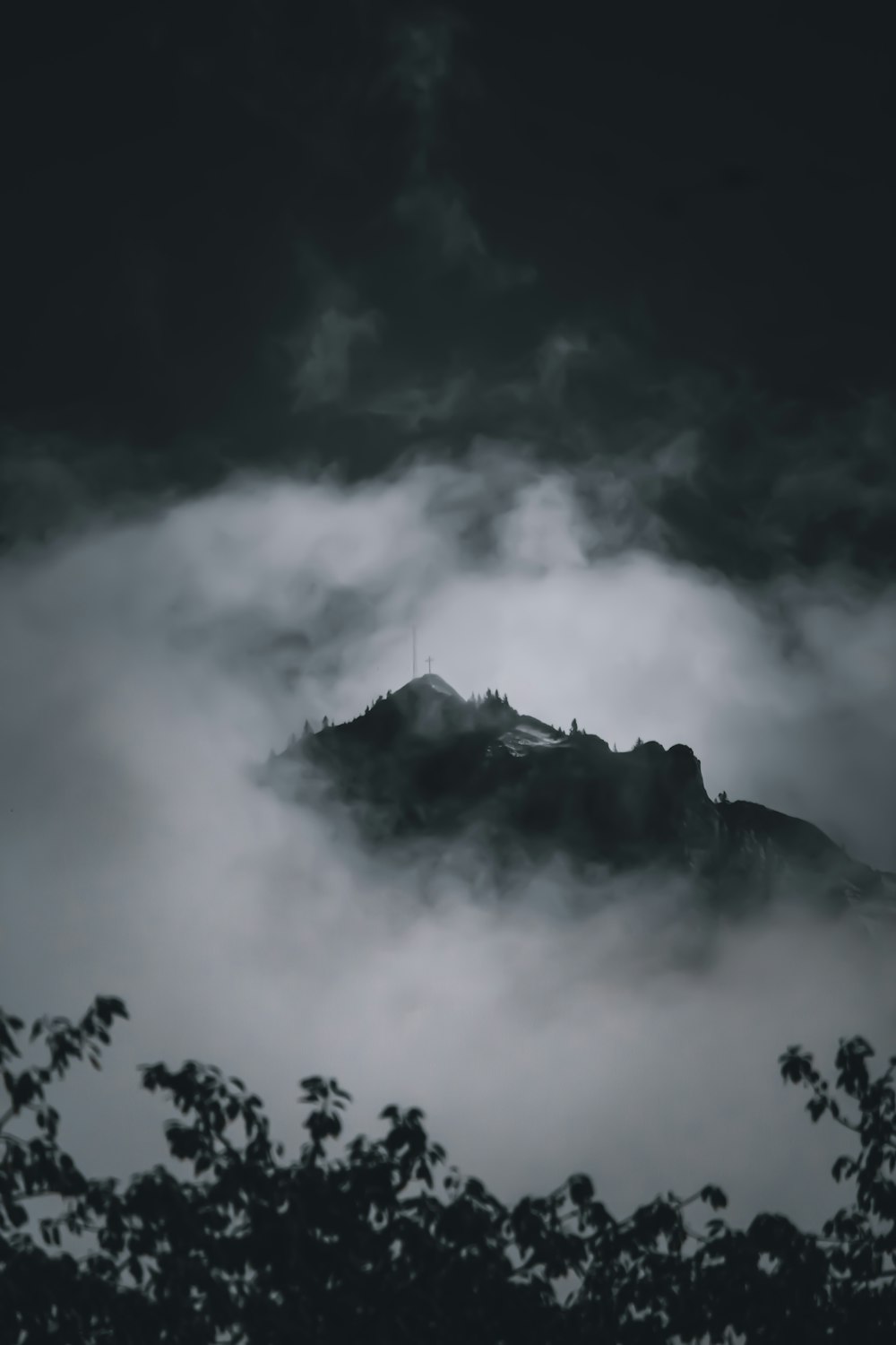 grayscale photo of clouds and mountain