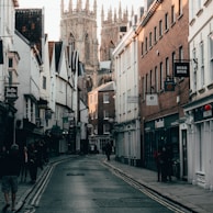 people walking on street between buildings during daytime