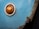 A close-up of a rusty, blue car body with an amber indicator light and visible corrosion along the edges.