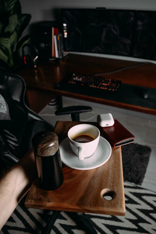 A sleek black and red themed office workspace with a laptop and coffee cup.
