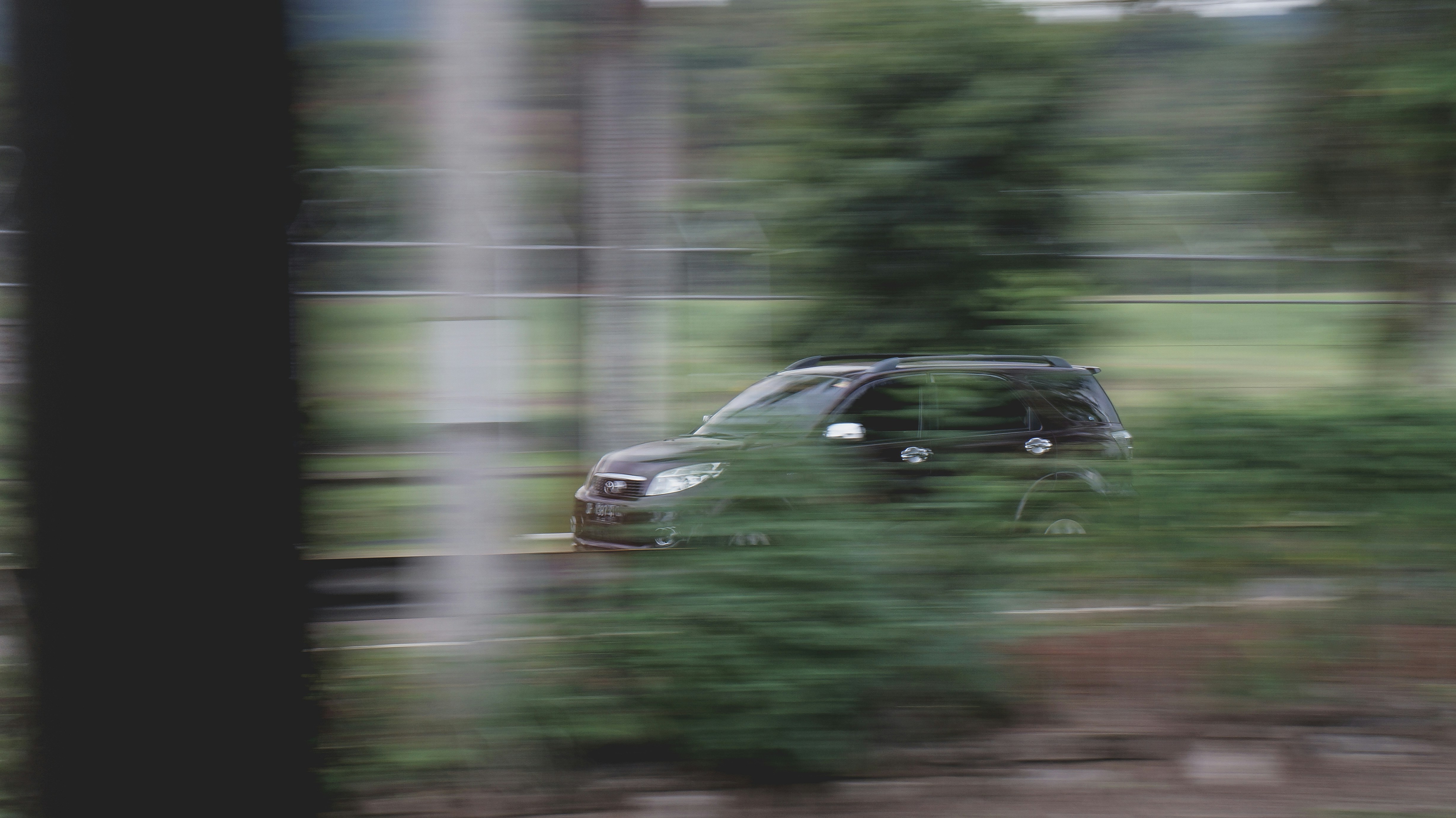 black sedan on road during daytime