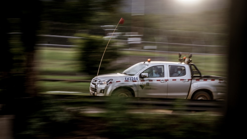 white chevrolet crew cab pickup truck on road during daytime