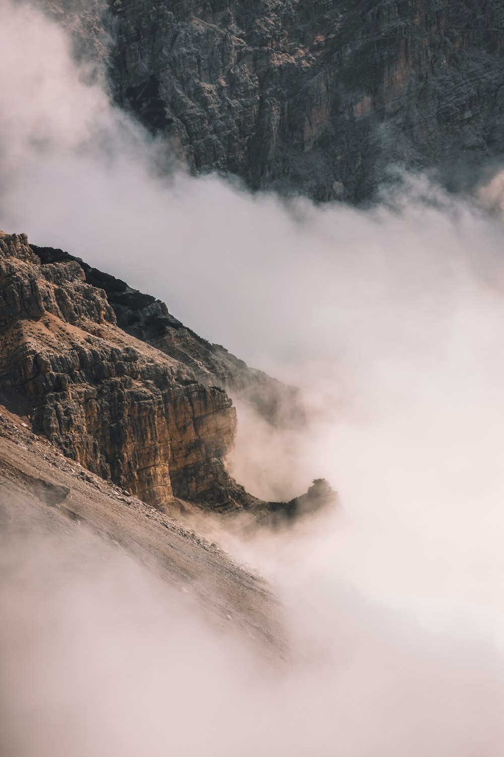 brown rocky mountain with fog