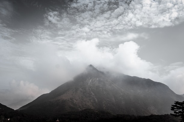 white clouds over brown mountain