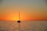 silhouette of boat on sea during sunset