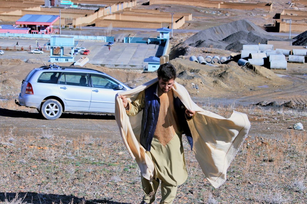 woman in brown and beige long sleeve dress standing on ground during daytime